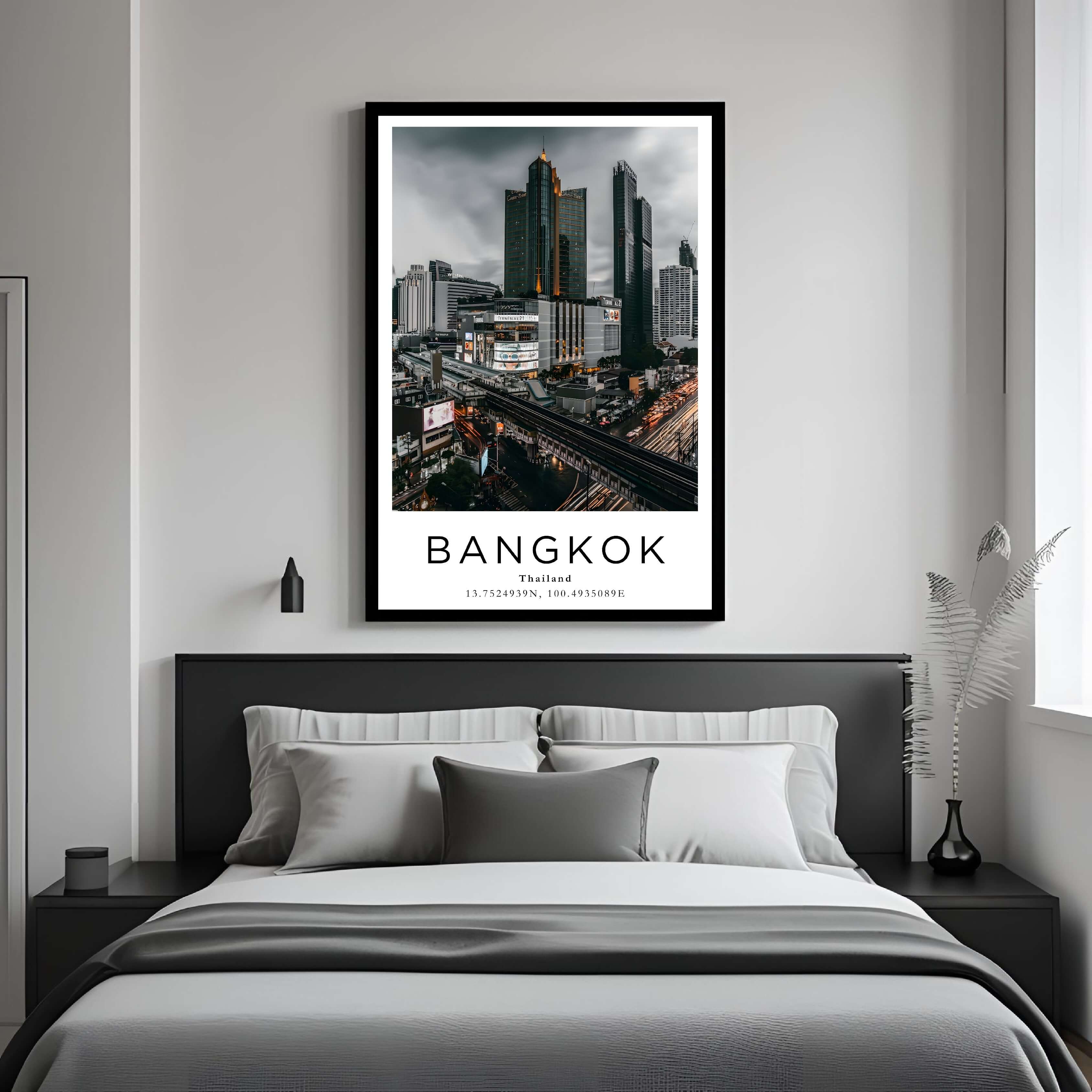 A curated art gallery wall featuring a framed Bangkok poster as the centerpiece among other prints.