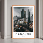 A framed urban cityscape print of Bangkok, Thailand, with a rustic red oak wood frame, perfect for home or office decor.