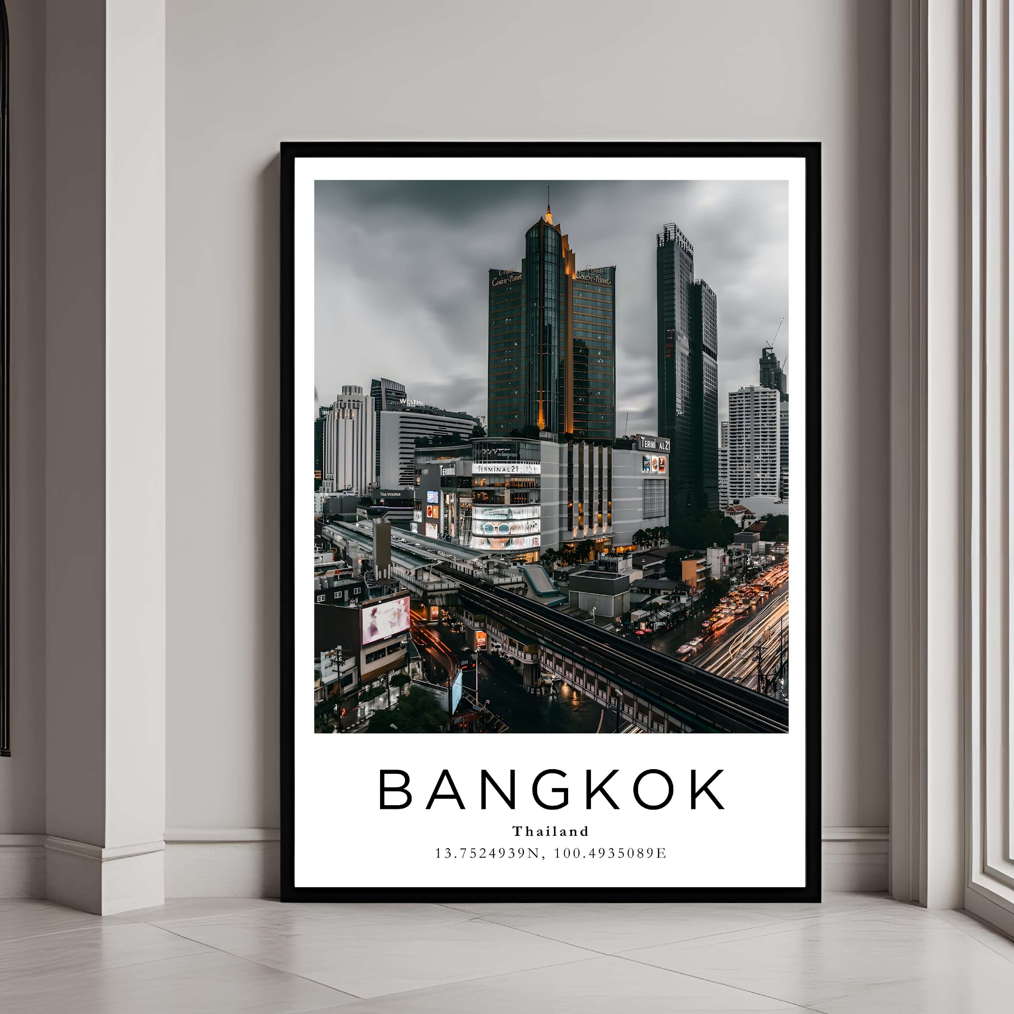 A framed poster of Bangkok, Thailand's cityscape with a black frame, styled in a modern interior setting.