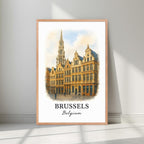Framed Grand-Place Guildhalls art in a natural Red Oak wood frame. Emphasizes the warm, historical tones of the facades.