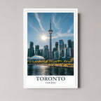 A framed art print of the Toronto skyline and waterfront with a minimalist white frame, perfect for a clean, contemporary decor style.