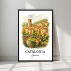 Framed art print of a picturesque Catalonian medieval village and historic stone bridge in a sleek black Ayous wood frame. Ideal for luxury Spanish or European decor.