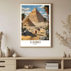 A framed art print depicting the stunning Giza Pyramids and desert landscape, styled to complement a light and airy, adventure-themed interior.