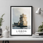 A framed travel poster of the Belém Tower displayed on an office wall, adding an element of professional and artistic flair.