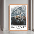 A framed print of Hallstatt, Austria, with a rustic red oak wood frame, highlighting the charming village and snowy mountains.