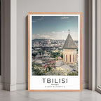 A framed print of Tbilisi, Georgia, with a rustic red oak wood frame, highlighting the city's historic charm.