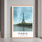 A framed print of Paris, France, with a rustic red oak wood frame, highlighting the iconic landmark.