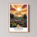 A framed, vibrant illustration of a Florida tropical sunset and modern skyline with a light wood frame, featuring palm trees and colorful houses.