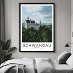A curated art gallery wall that includes a framed Neuschwanstein Castle poster, showcasing a creative and personalized collection of prints.