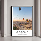 A framed poster of hot air balloons over Göreme, Turkey, with a classic black frame, styled in a modern interior.