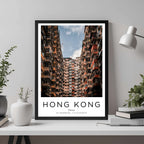  A framed travel poster of Hong Kong displayed on a wall in a home office, adding an element of professional and artistic flair.