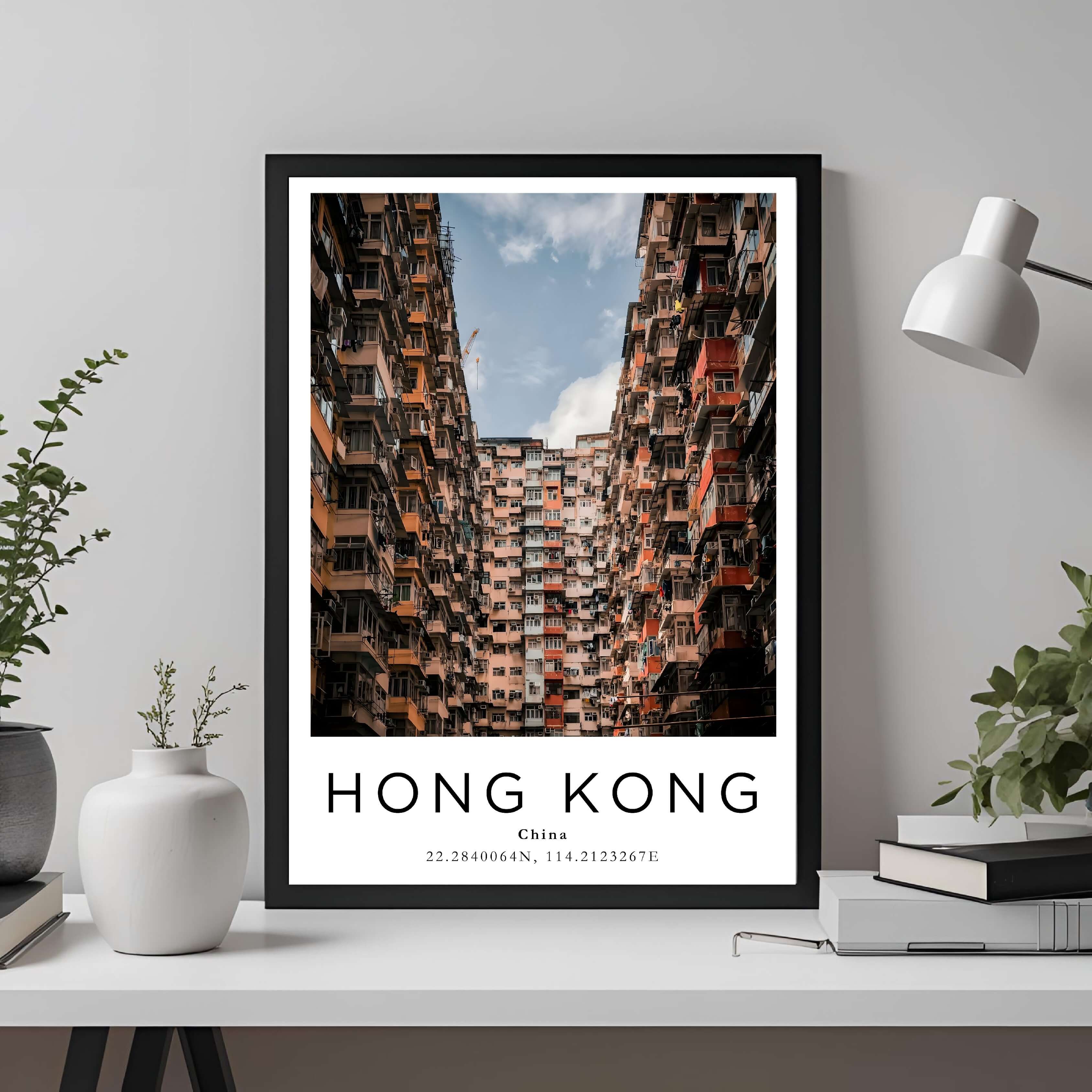  A framed travel poster of Hong Kong displayed on a wall in a home office, adding an element of professional and artistic flair.