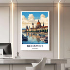 A framed travel poster of Budapest displayed on a wall in a home office, adding an element of creative and sophisticated flair.