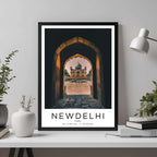  A framed travel poster of New Delhi displayed on a wall in a home office, adding an element of professional and artistic flair.