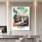 A framed travel poster of Madrid displayed on a wall in a home office, adding an element of creative and inspiring flair.