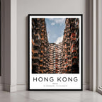 A framed poster of Hong Kong’s dense urban architecture, with a classic black frame, styled in a modern interior.
