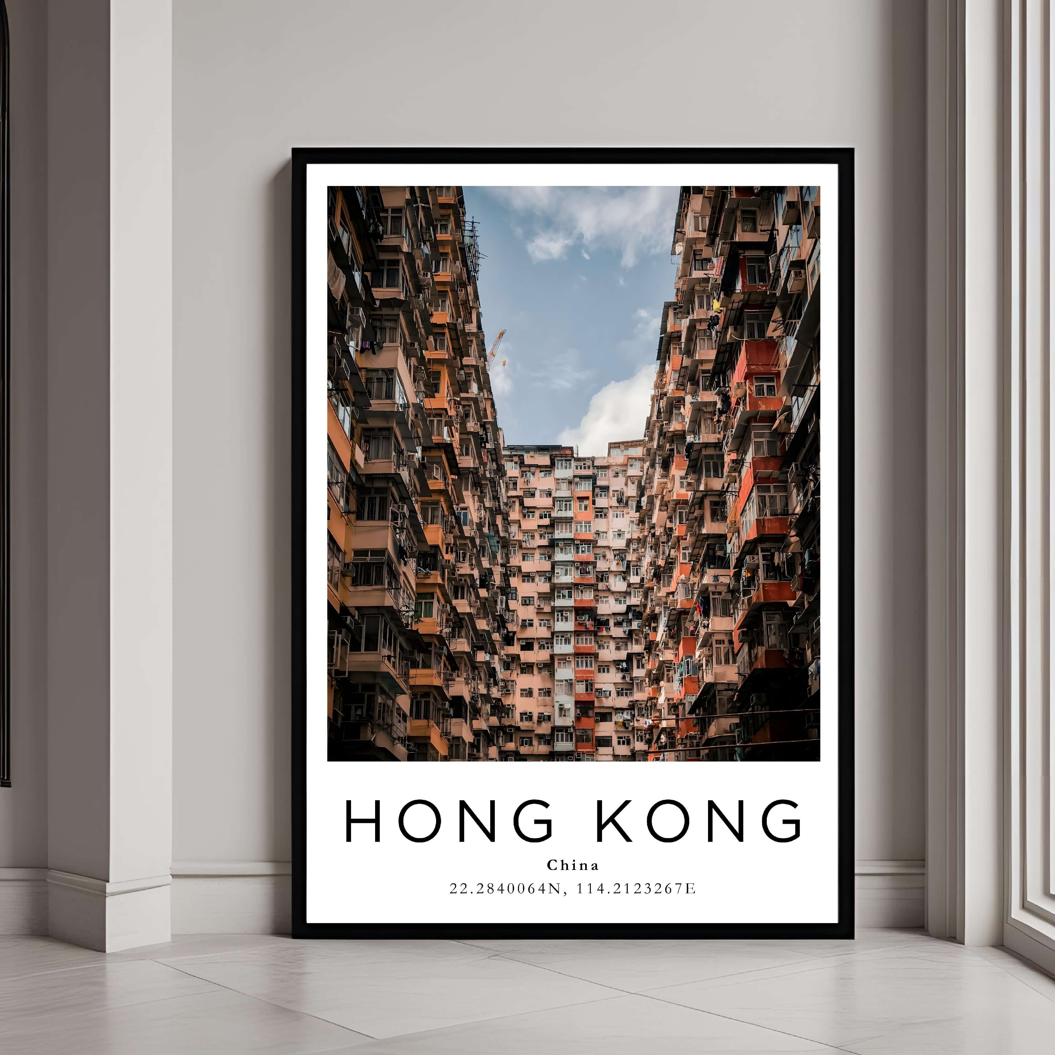 A framed poster of Hong Kong’s dense urban architecture, with a classic black frame, styled in a modern interior.