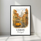 Framed art print of Lisbon's iconic yellow tram and colorful Alfama street in a sleek black Ayous wood frame. Ideal for luxury Portuguese travel decor.
