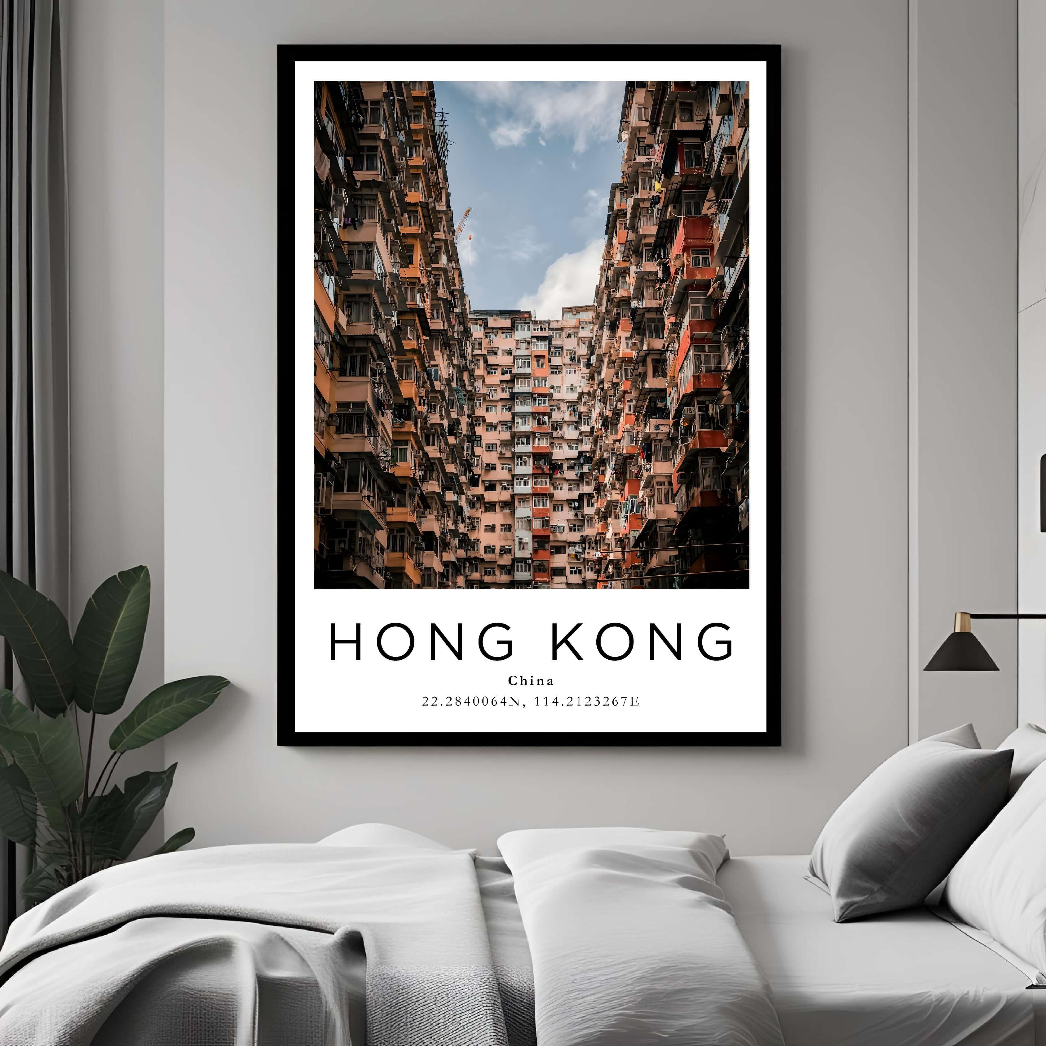  A framed art print of Hong Kong's unique buildings decorating a bedroom wall, creating a simple and elegant atmosphere.