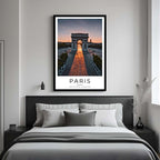 A framed art print of the Arc de Triomphe decorating a bedroom wall, creating a serene and romantic atmosphere.