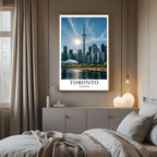 A framed art print of the Toronto skyline decorating a bedroom wall, creating a peaceful and luxurious atmosphere.