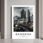 A framed art print of Bangkok's cityscape decorating a bedroom wall with a clean and contemporary design.