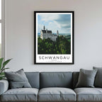 A framed poster of Neuschwanstein Castle hanging in a living room, enhancing the modern and sophisticated look of the space.