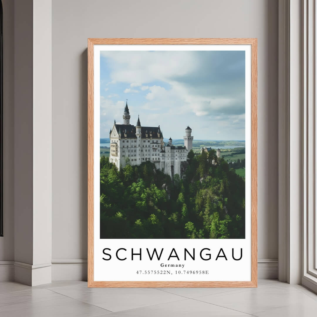 A framed poster of Neuschwanstein Castle in Schwangau, Germany, with a red oak wood frame, styled in a luxurious modern interior.