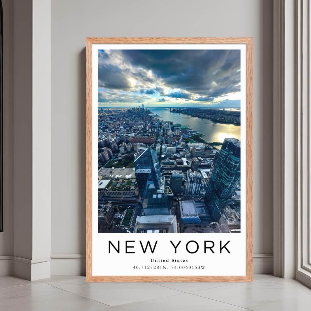 A framed poster of the New York City skyline at sunset, with a red oak wood frame, styled in a luxurious modern interior.