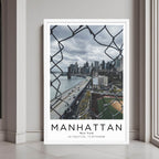  A framed art print of the Manhattan cityscape with a minimalist white frame, perfect for a modern decor style.