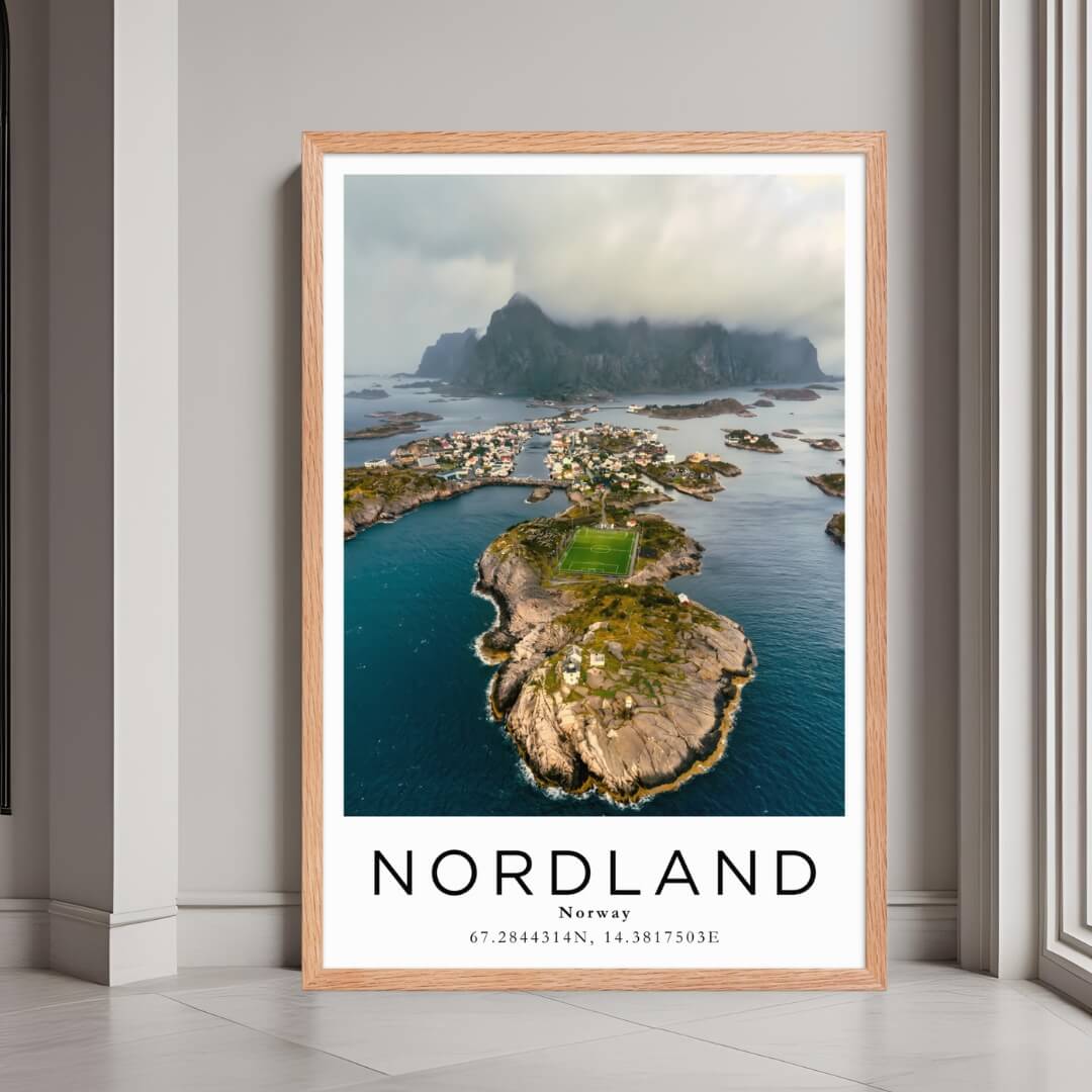 A framed poster of a village in Nordland, Norway, with a red oak wood frame, styled in a luxurious modern interior.