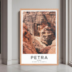 A framed poster of The Treasury in Petra, Jordan, with a red oak wood frame, styled in a luxurious modern interior.