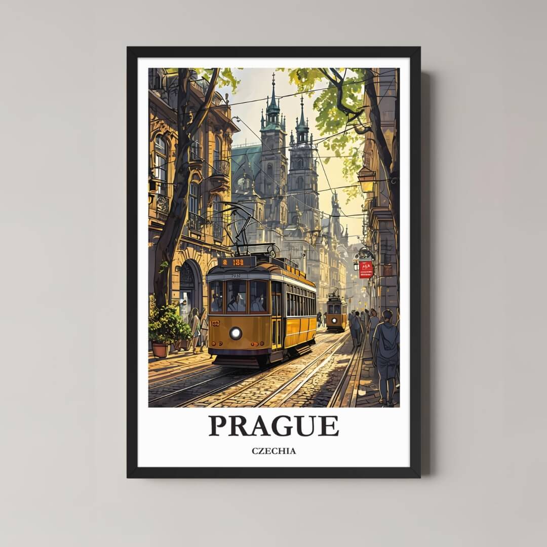 A framed, vibrant illustration of a Prague street scene with a yellow tram and historic buildings, featuring the St. Vitus Cathedral towers in the background, in a black frame.