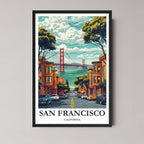 A framed, vibrant illustration of a downhill San Francisco street, showing Victorian buildings and the Golden Gate Bridge in the distance, in a classic black frame.