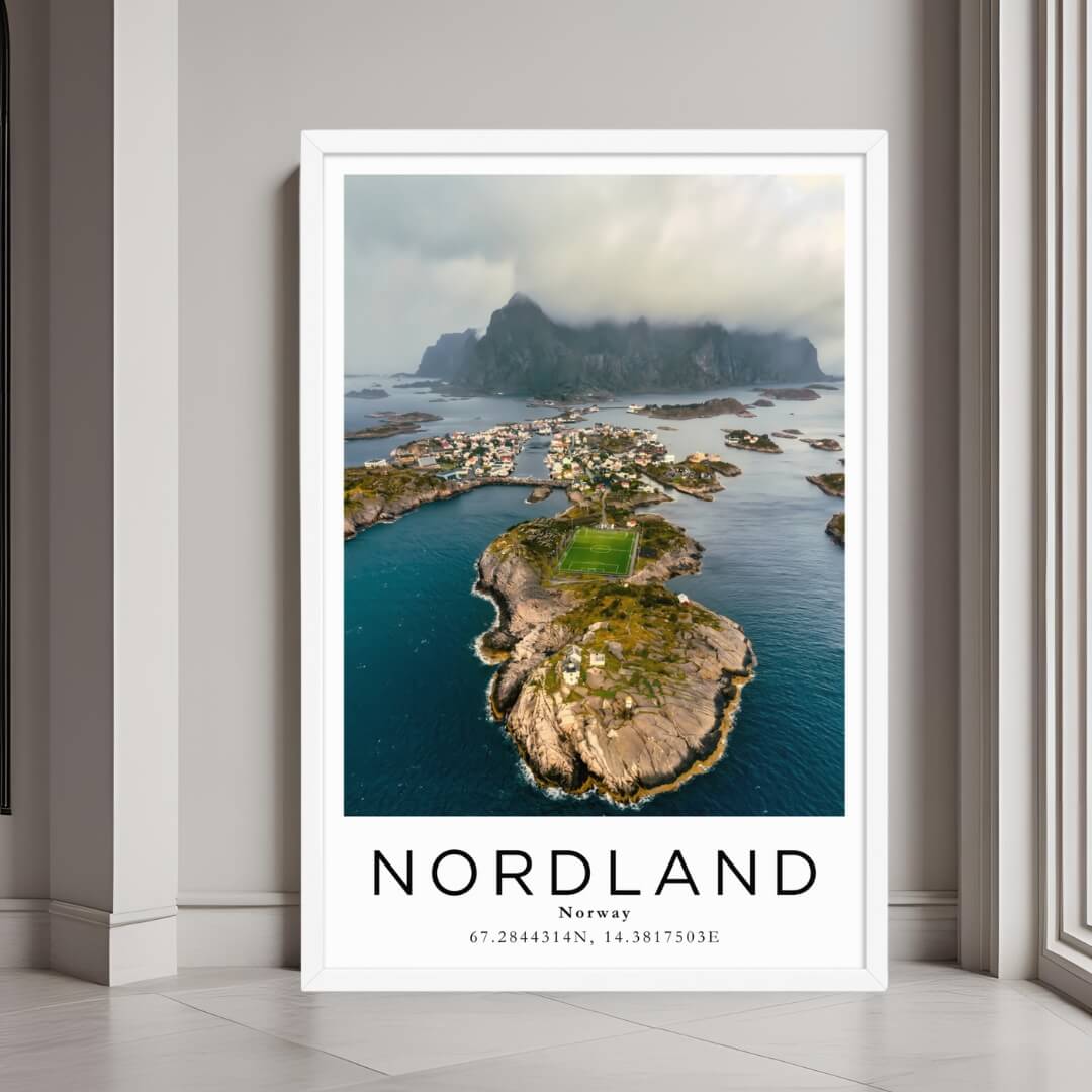 A framed wall art print of a Norwegian village and its unique landscape with a minimalist white frame.