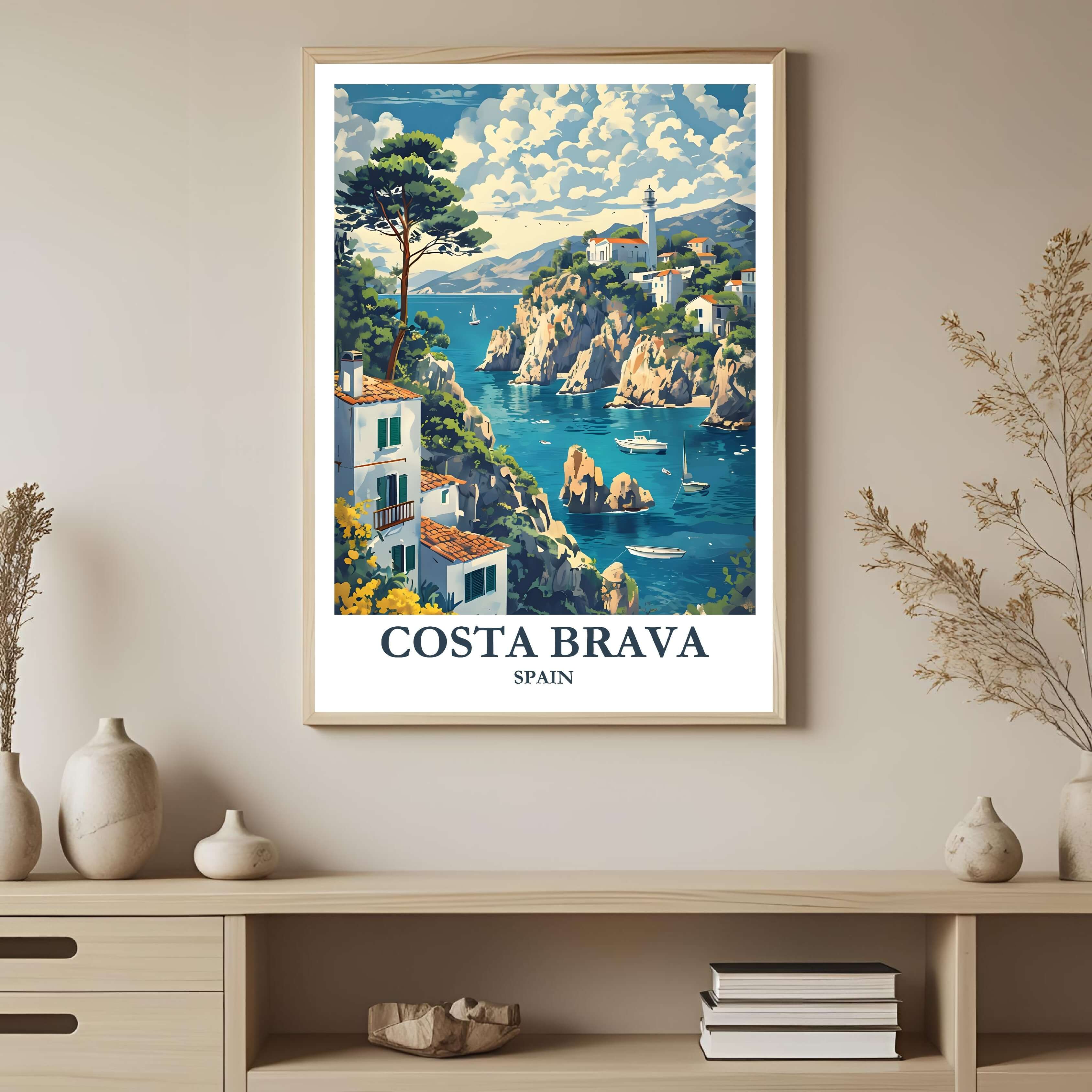 A framed art print depicting a vibrant seaside town and cliffs on the Costa Brava, styled to complement a light and airy interior.