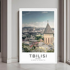A framed poster of the Tbilisi Old Town in Georgia with a clean white frame, styled in a modern interior.