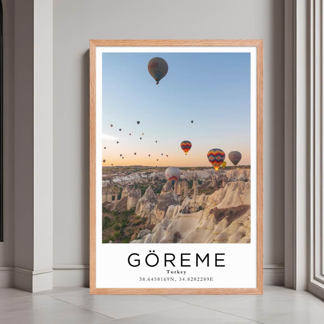 A framed print of Göreme, Turkey, with a rustic red oak wood frame, highlighting the unique rock formations and scenery.